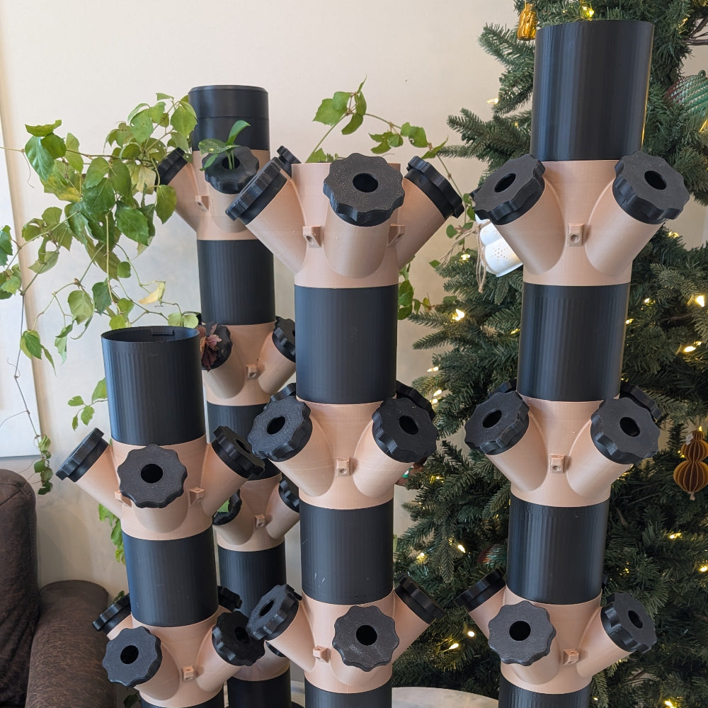 Indoor 4 tier aeroponic grow tower holding plants in vertical system
